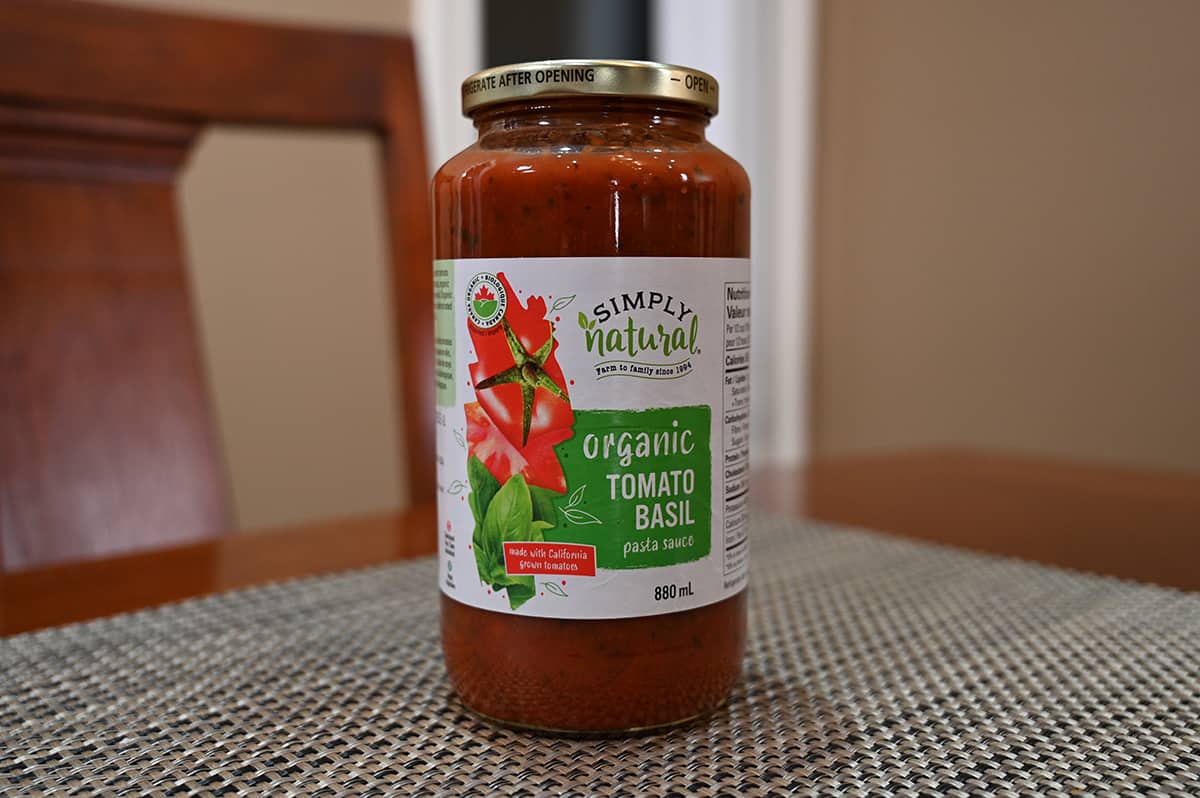 Image of the Costco Simply Natural Organic Tomato Basil Pasta Sauce jar sitting on a table.