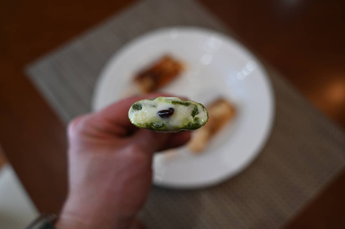 Image of a matcha latte bar with a bite taken out so you can see the tapioca balls inside.