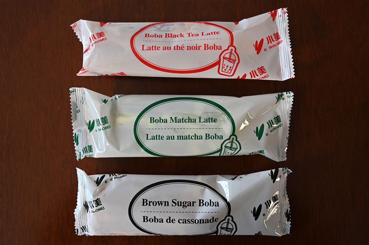 Image of the three flavors of bars showing their individual pacjaging sitting on a table.