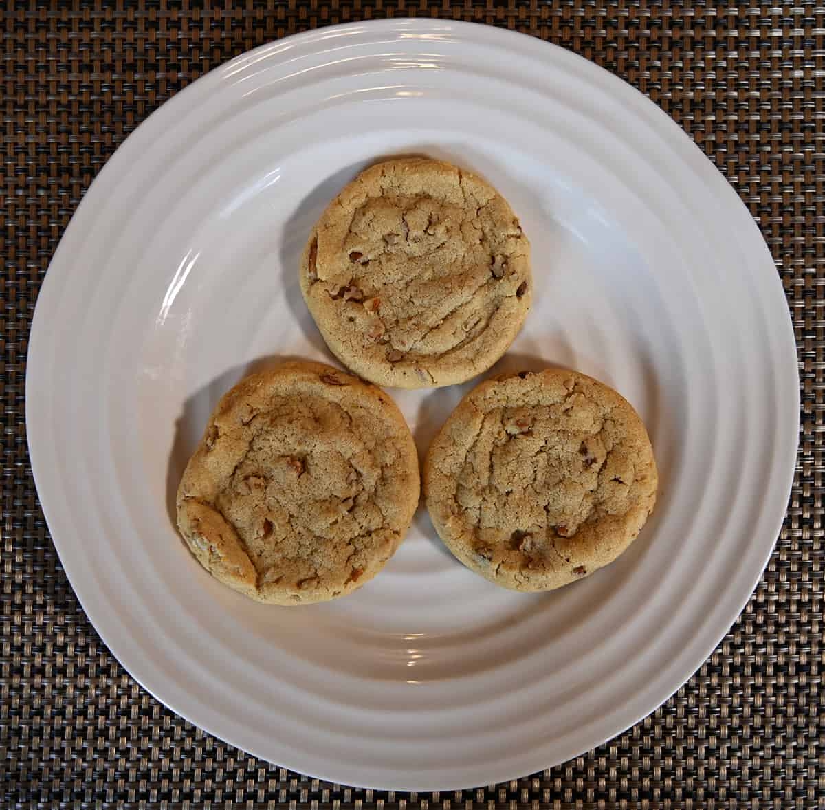 Top down image of three cookies on a white plate.