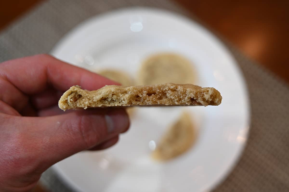 Closeup image of a cookie with a bite taken out of it so you can see the center of the cookie.