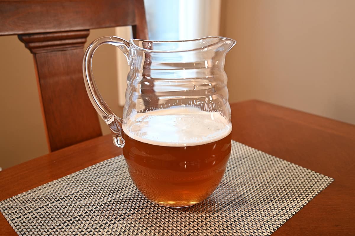 Image of a prepared pitcher of iced tea sitting on a table.