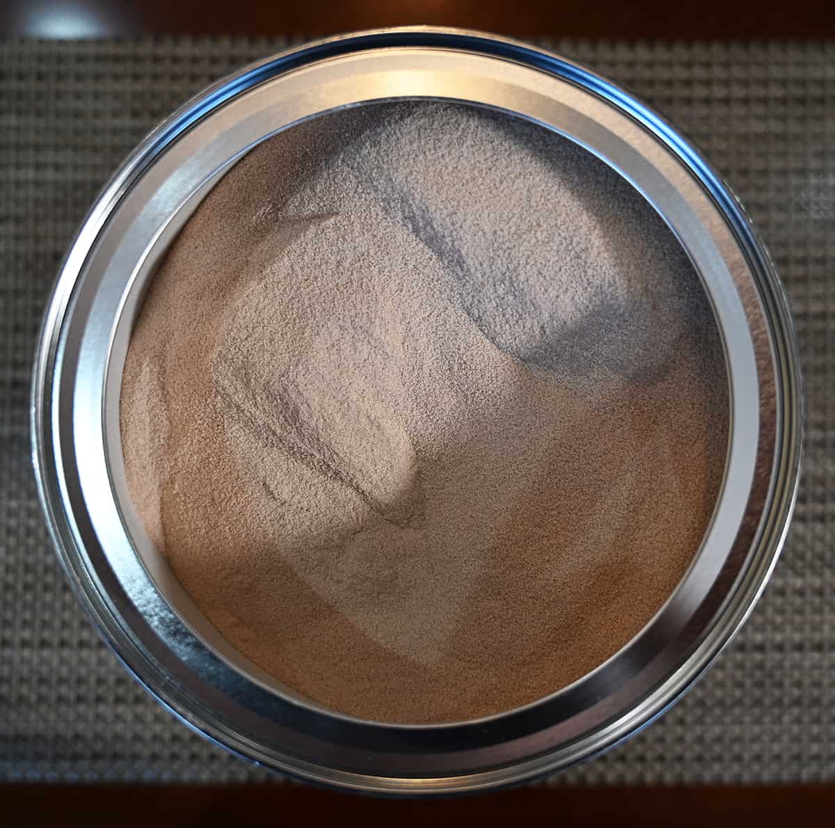 Top down image of an open container of the iced tea mix showing what the powder mix looks like.