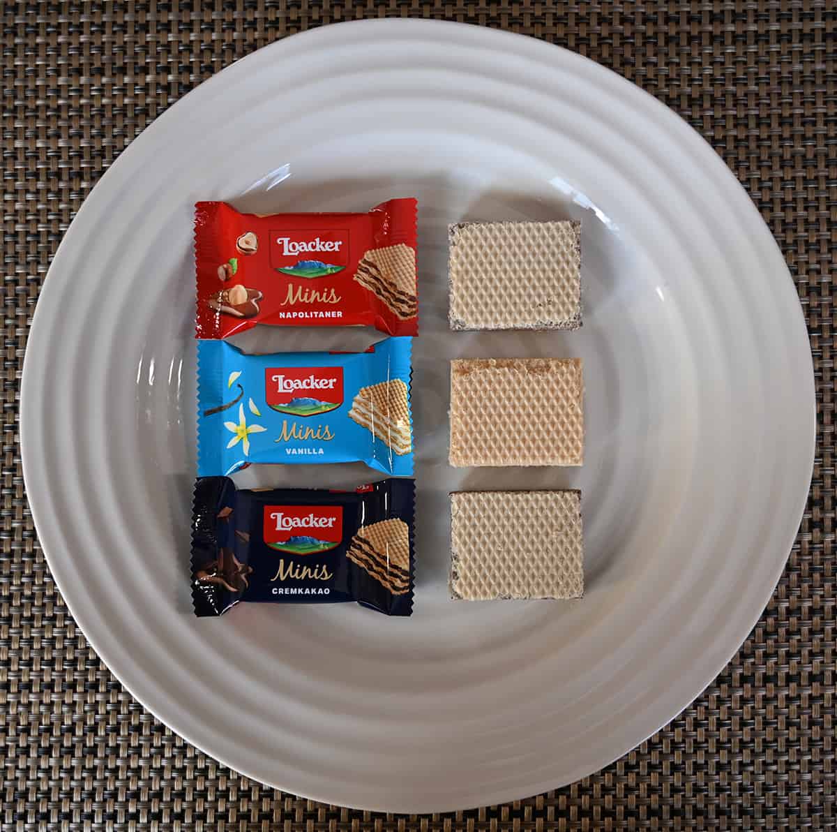 Image of all three flavors of wafer cookies unwrapped and served on a white plate beside their package.
