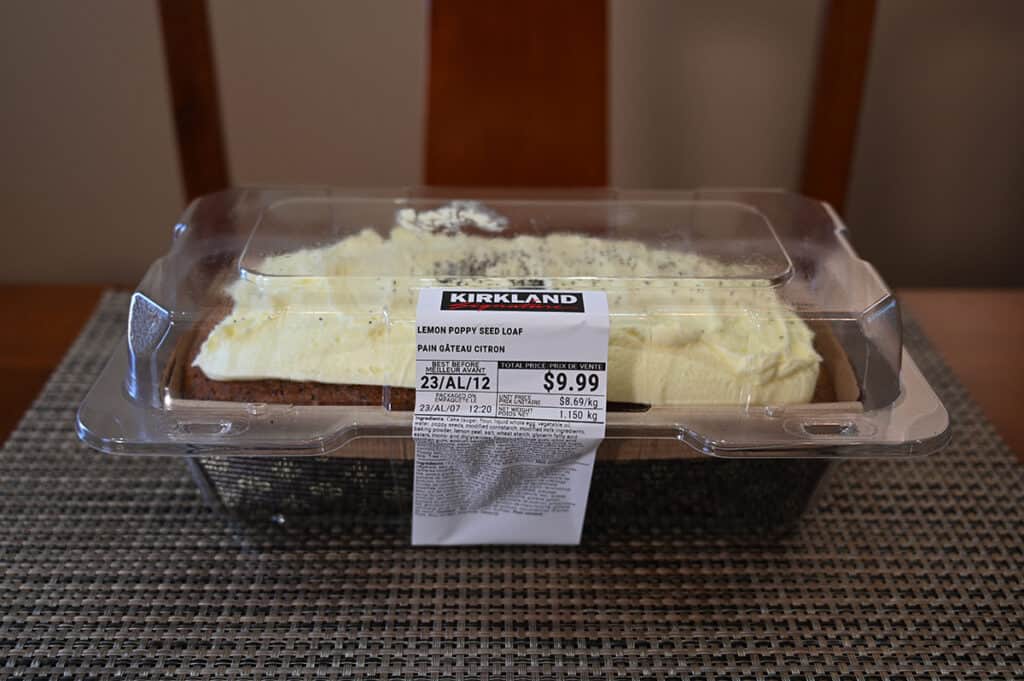 Side view image of the Costco Kirkland Signature Lemon Poppyseed Loaf in the container sitting on a table.