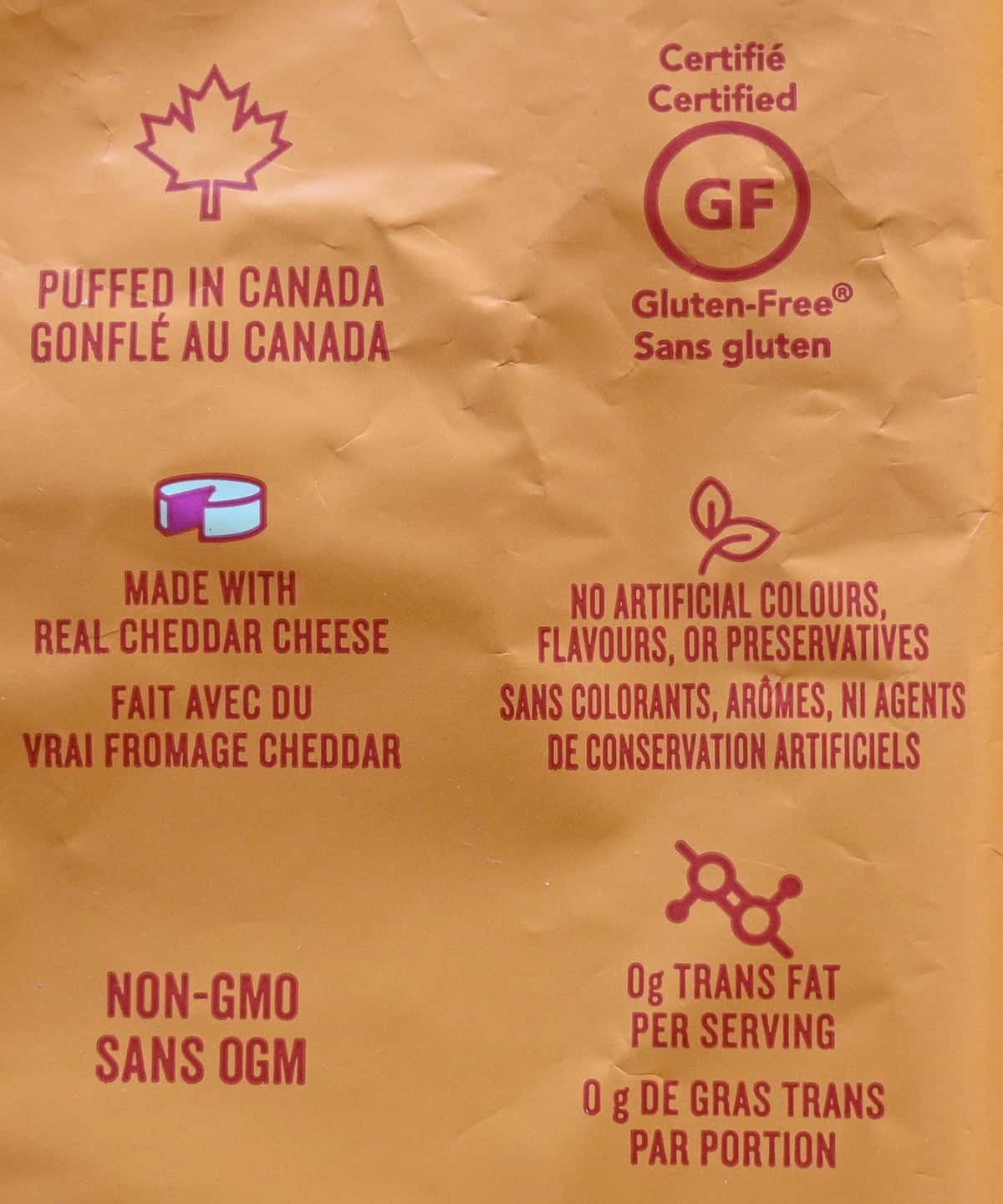 Image of the back of the bag of puffs stating that they are gluten-free and made with real cheddar cheese.