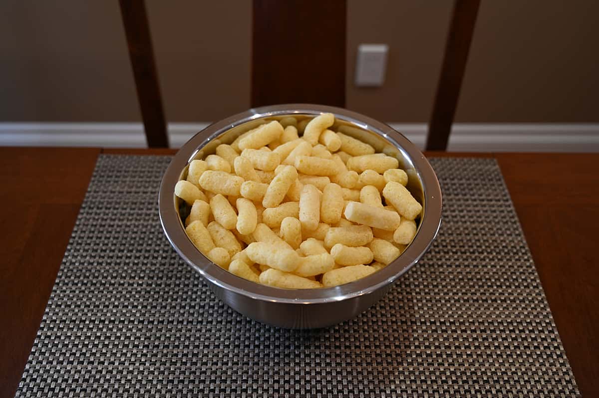 Image of a big metal bowl full of puffs sitting on a table.