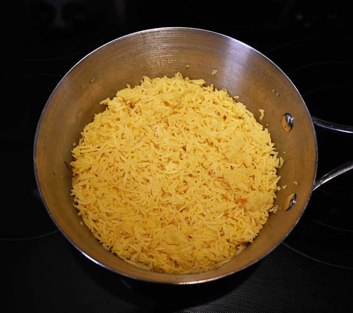 Top down image of a full pot of cooked rice.