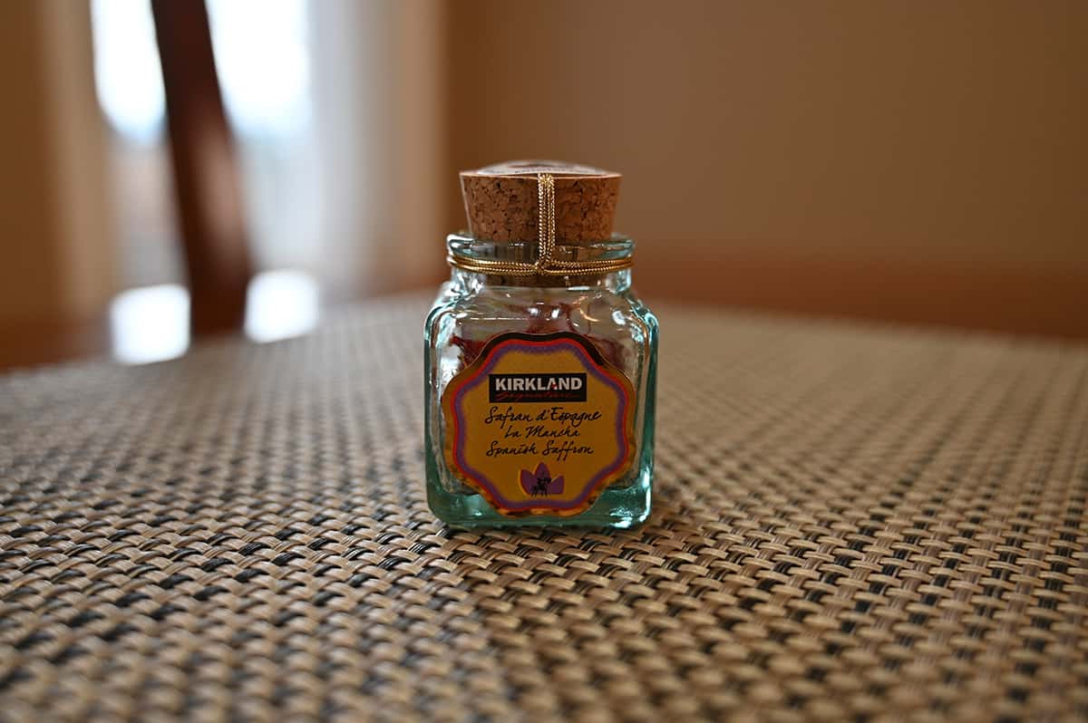 Image showing the one gram small glass jar of saffron sitting on a table.