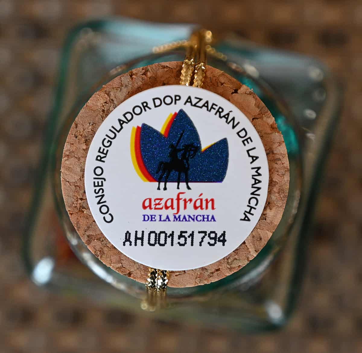 Top down image of the number labeled on the jar guaranteeing the saffron is from the La Mancha region in Spain.