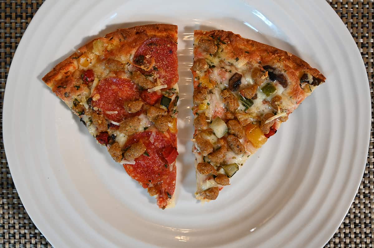 Top down image of two slices of pizza served on a white plate.