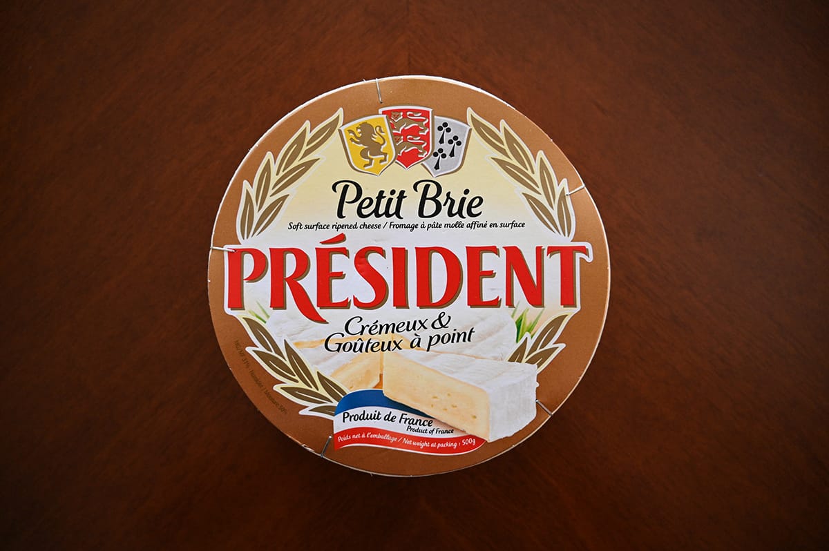 Top down image of the Costco Président Petit Brie wheel sitting on a dining room table.