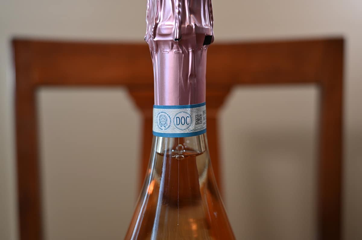 Closeup image of the top wrapper with on the bottle with the DOC label on it guaranteeing production methods and where it's from.