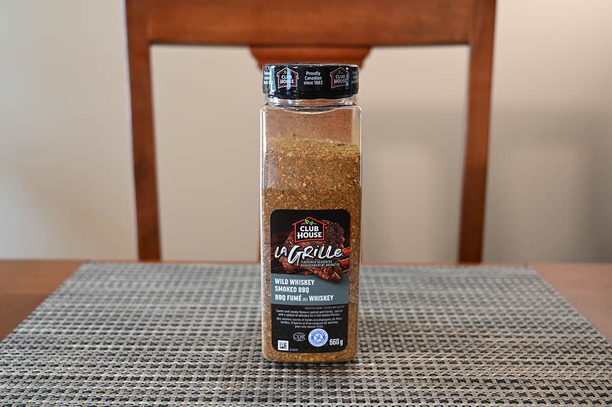 Costco Club House La Grille Wild Whiskey Smoked BBQ Seasoning container sitting on a table.