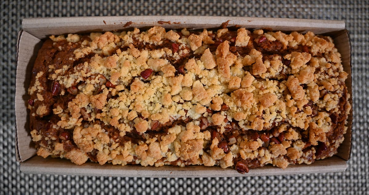 Top down image of the apple fritter loaf cake in the package, showing the streusel topping.