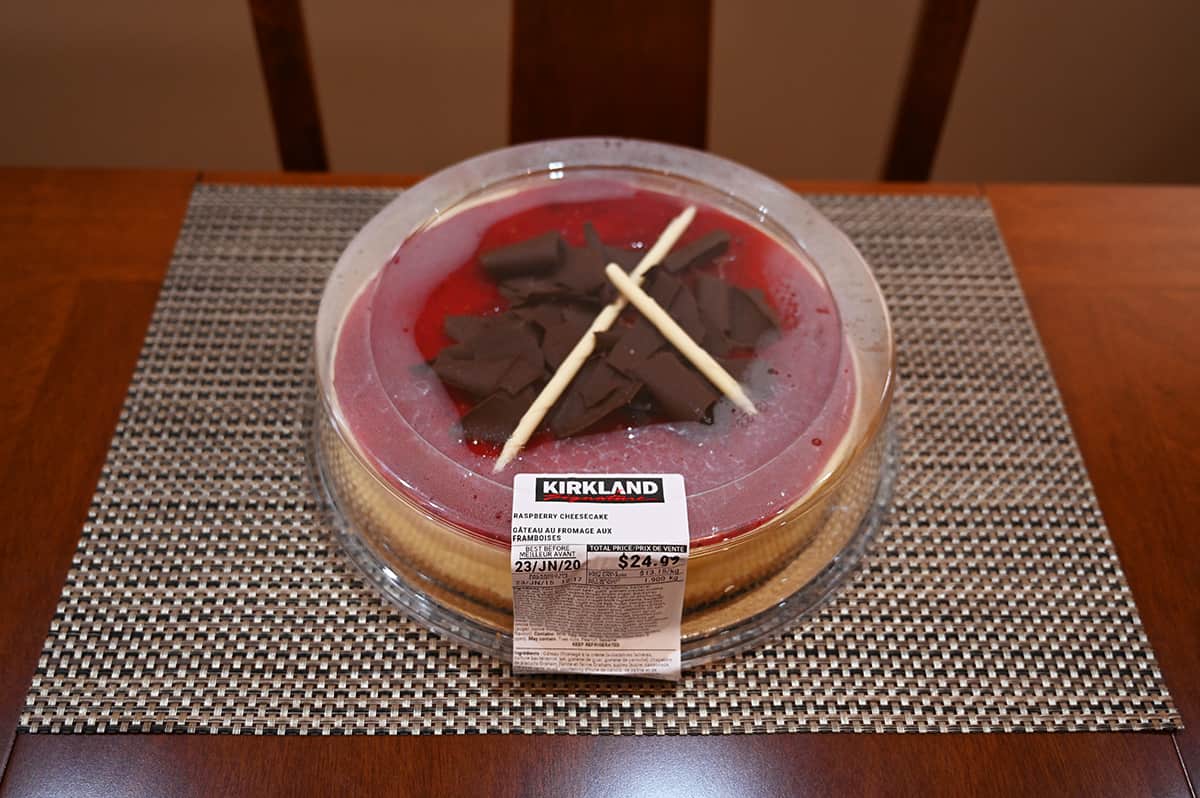 Image of the Costco Kirkland Signature Raspberry Cheesecake in the container sitting on a table.