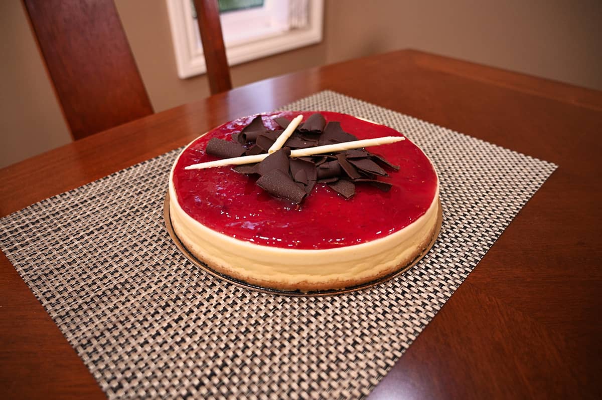 Image of the raspberry cheesecake out of the container sitting on a table. 