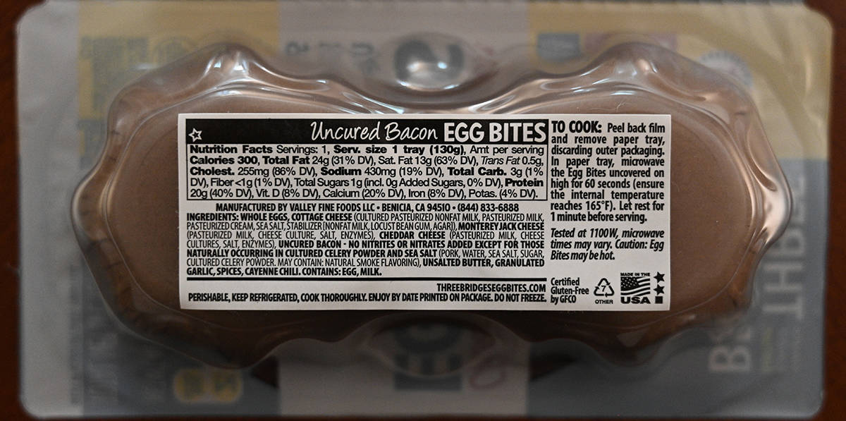 Image of the back label of the uncured bacon egg bites showing calories, ingredients and how to cook.