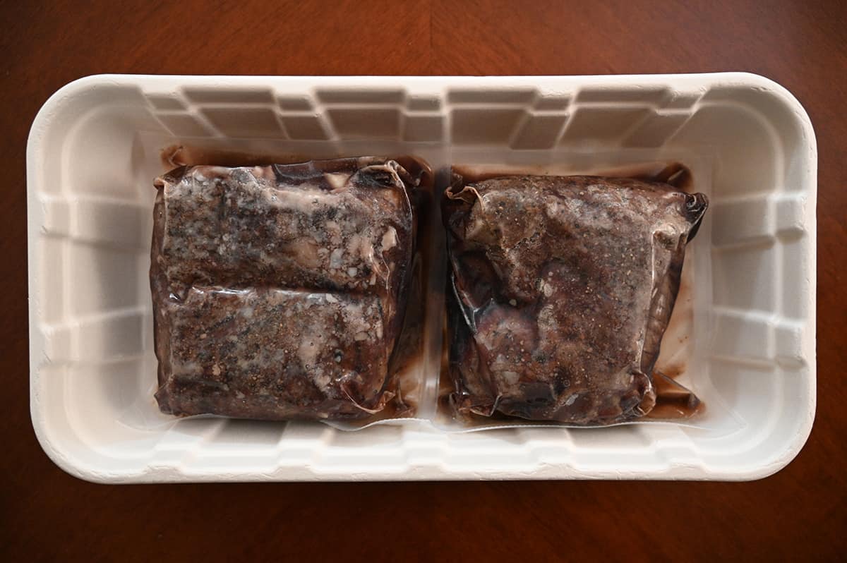 Top down image of two vacuum sealed packs of sirloin in a white plastic tray.
