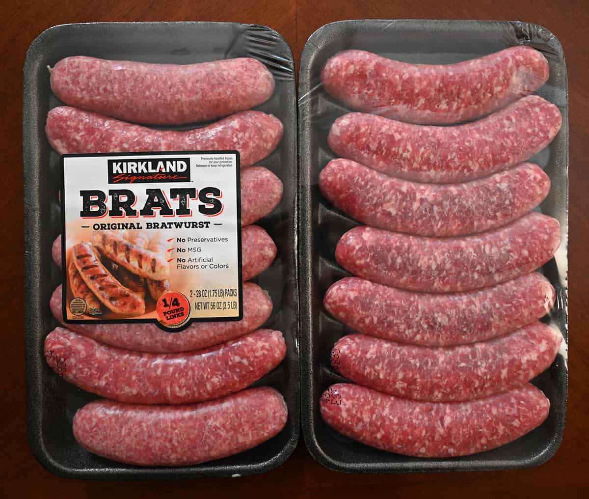 Top down image of two packs of brats, unopened and uncooked. Each package has 7 brats in it. 