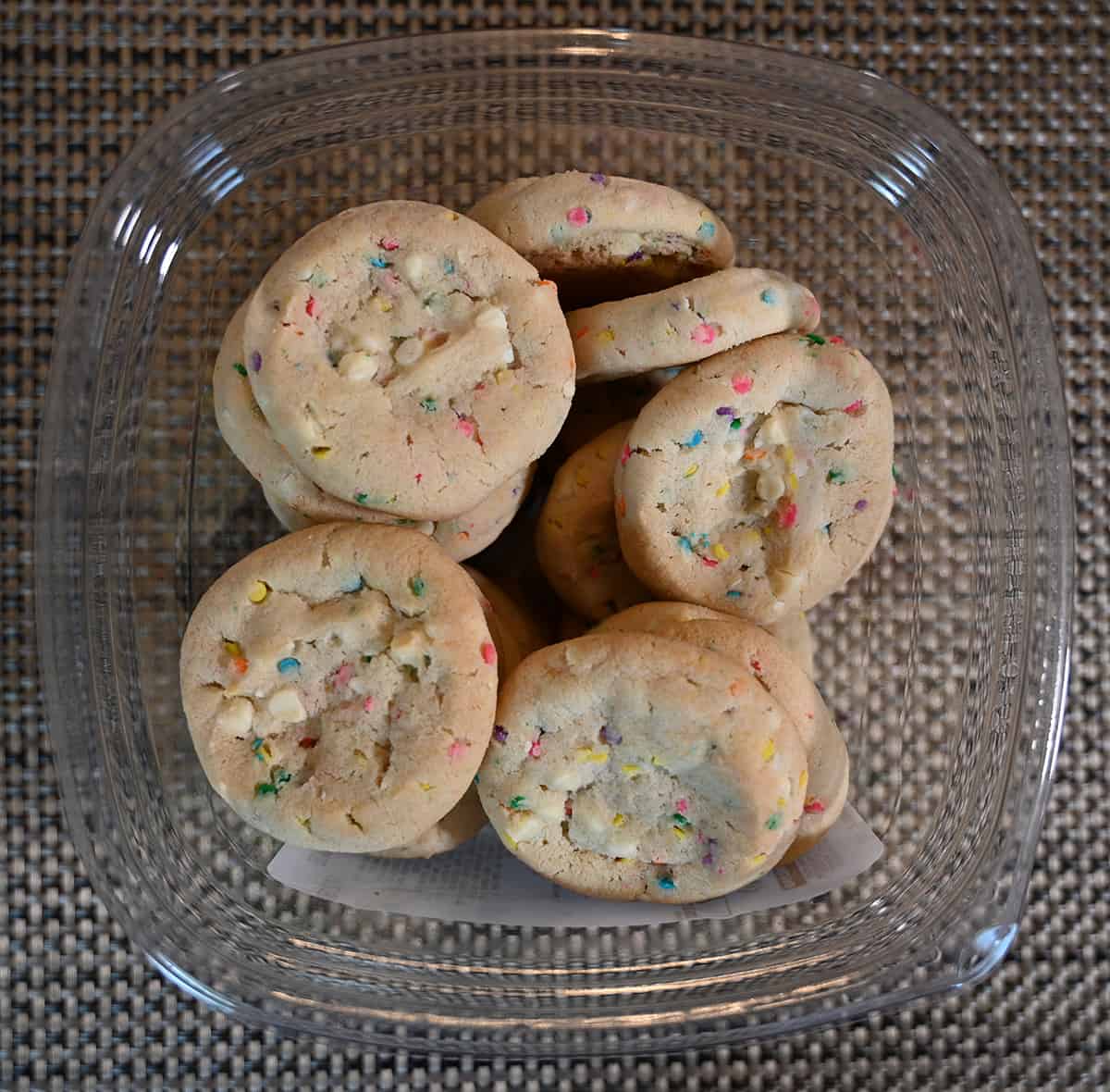 Top down image of an open container of confetti cookies so you can see the cookies inside.