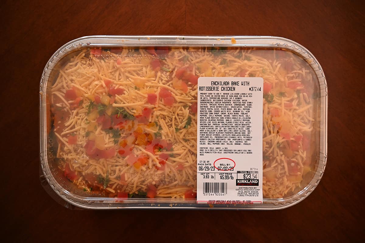 Top down image of the Costco Kirkland Signature Enchilada Bake tray sitting on a table unopened.