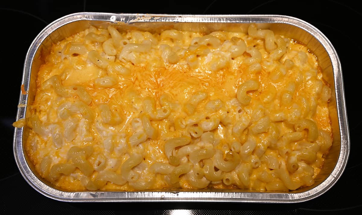 Top down image of the mac and cheese just out of the oven baked. Showing the melted shredded cheese on the pasta noodles.