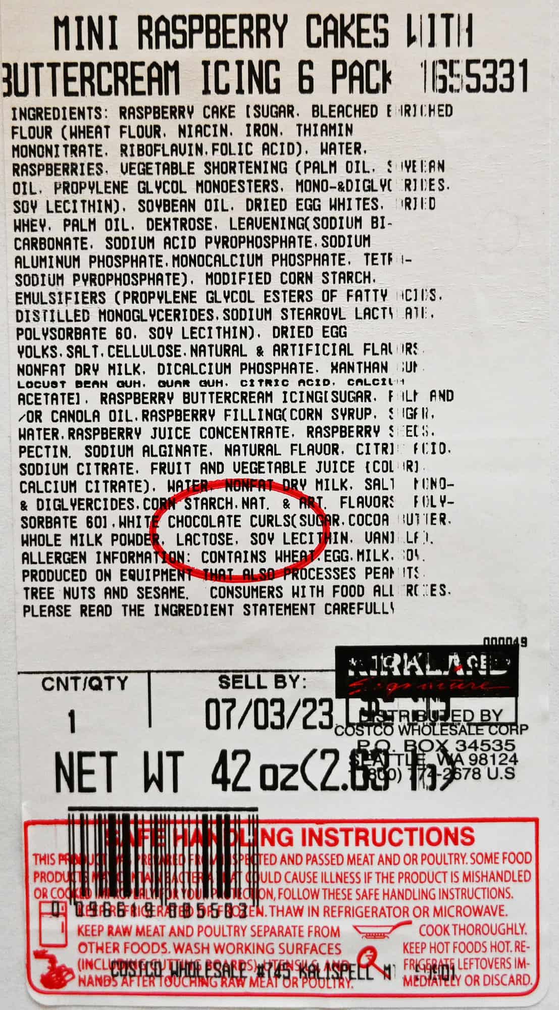 Closeup image of the label on the package of the raspberry mini cakes showing ingredients, best before date and cost.