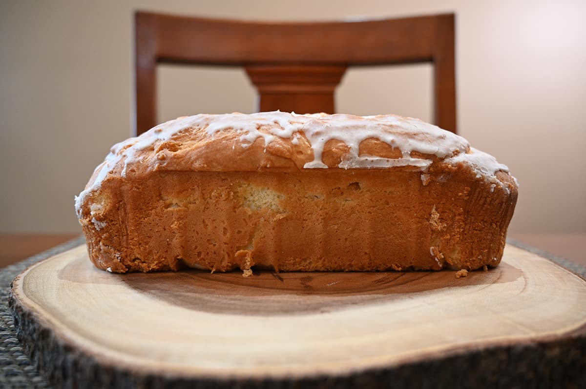 Side view image of the pound cake served on a wooden cutting board.
