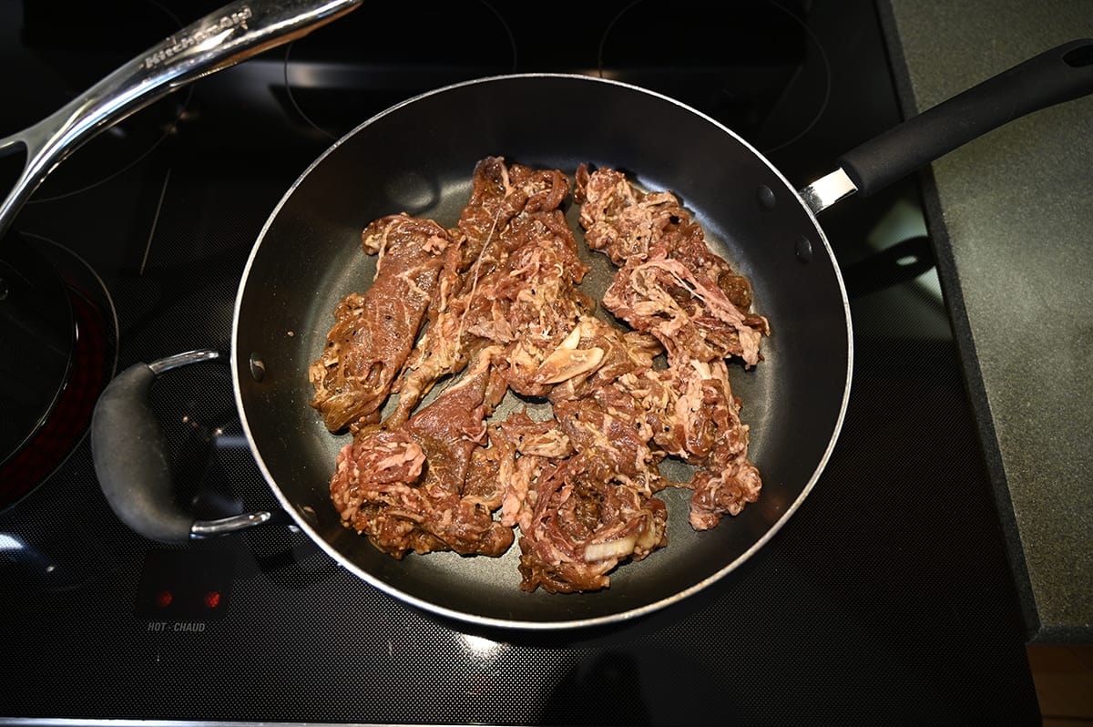 Top down image of the beef bulgogi in a frying pan before cooking it.