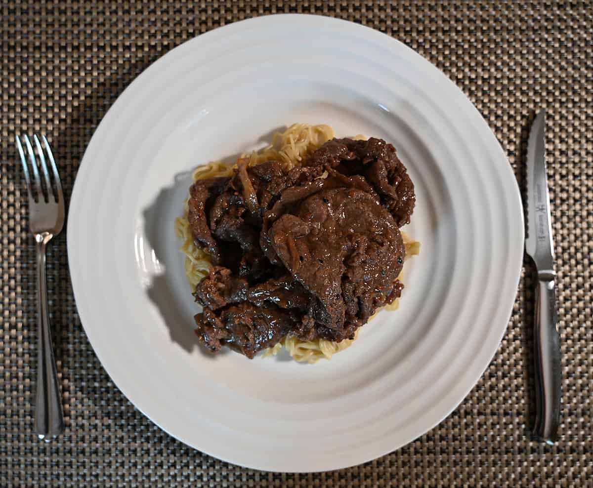 Top down image of the beef bulgogi cooked and served over a bed of noodles. 