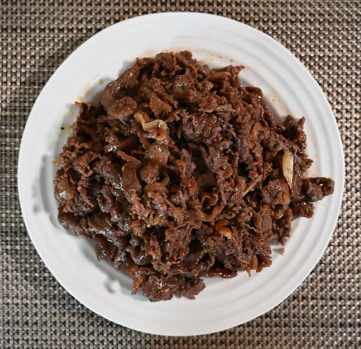 Top down image of a full plate of cooked beef bulgogi.