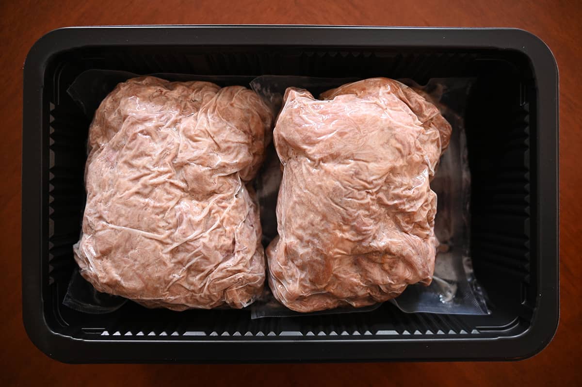 Top down image of two bags of vacuum sealed pork in a plastic tray.