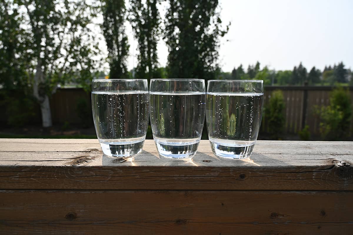 Image showing three clear glasses with canned sparkling water in each glass, the sparkling water is clear.