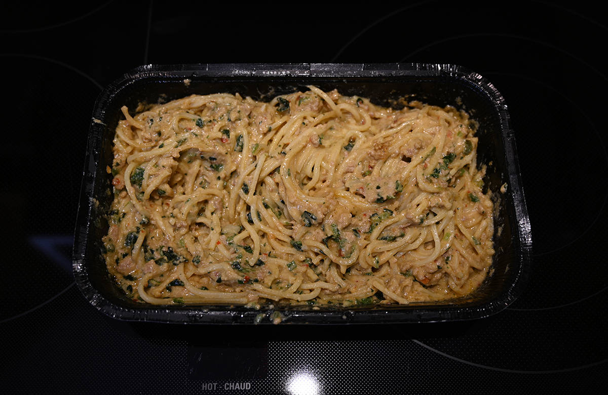 Top down image of a tray of cooked Dan Dan Noodles.