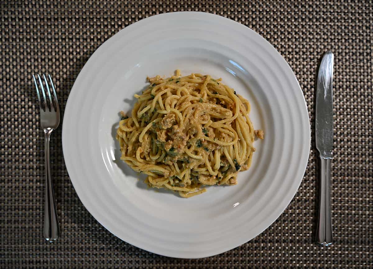Top down image of a white plate with a serving of Dan Dan Noodles served on it.