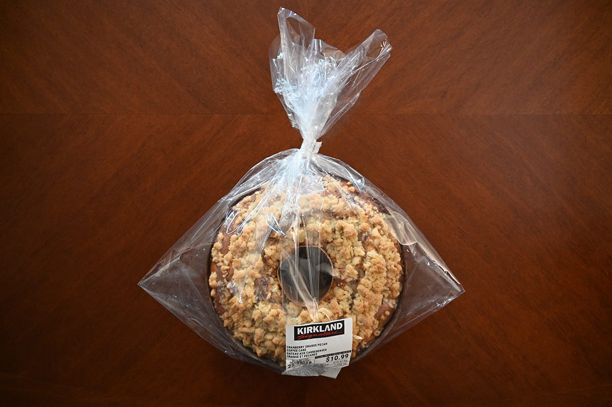 Image of the Costco Kirkland Signature Cranberry Orange Pecan Coffee Cake unopened sitting on a table.