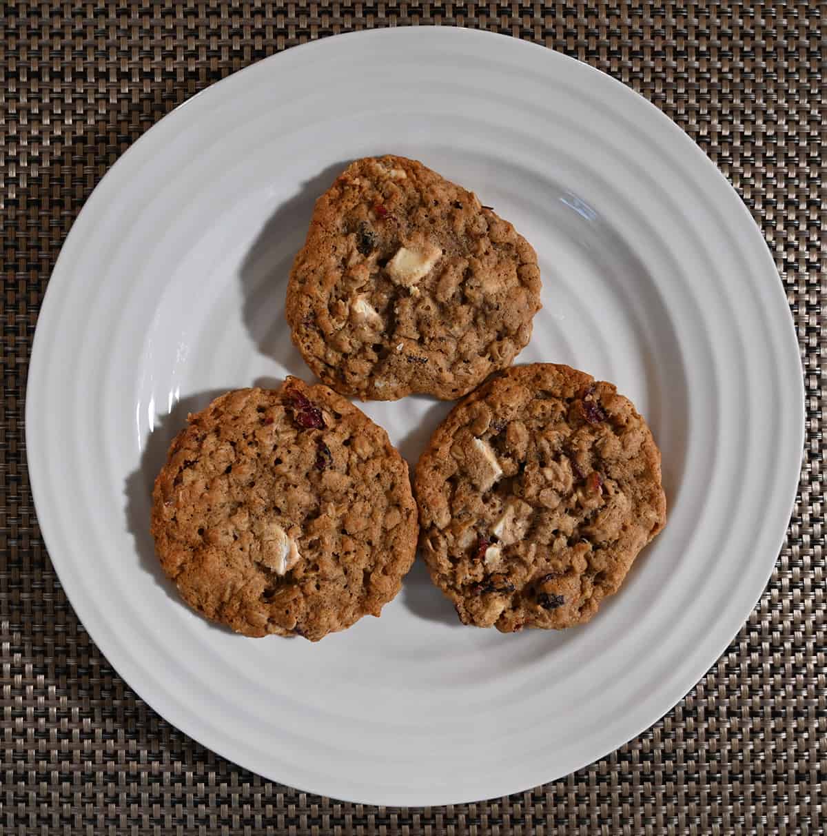 Top down image of three cookies served on a white plate.