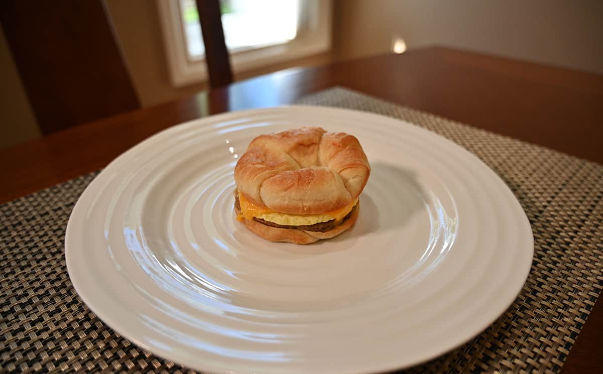 Image of a cooked croissant sandwich served on a white plate.