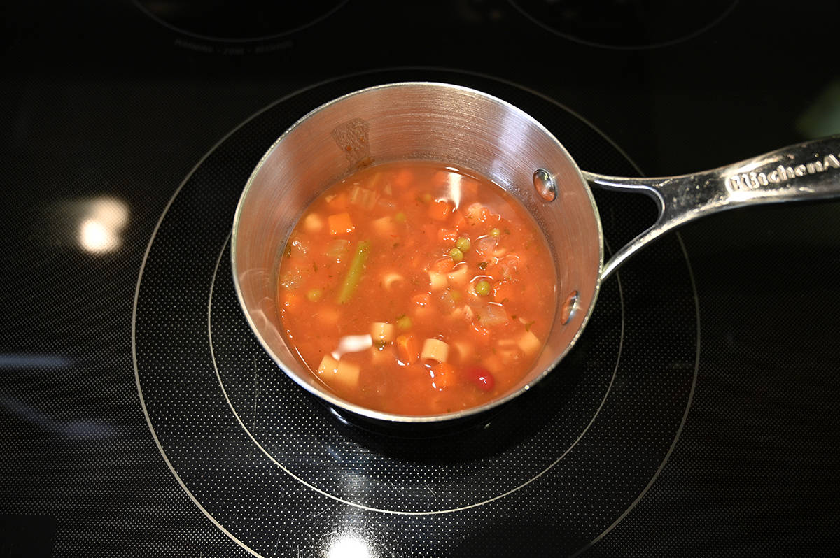 Top down image of a pot of the soup simmering on the stove.