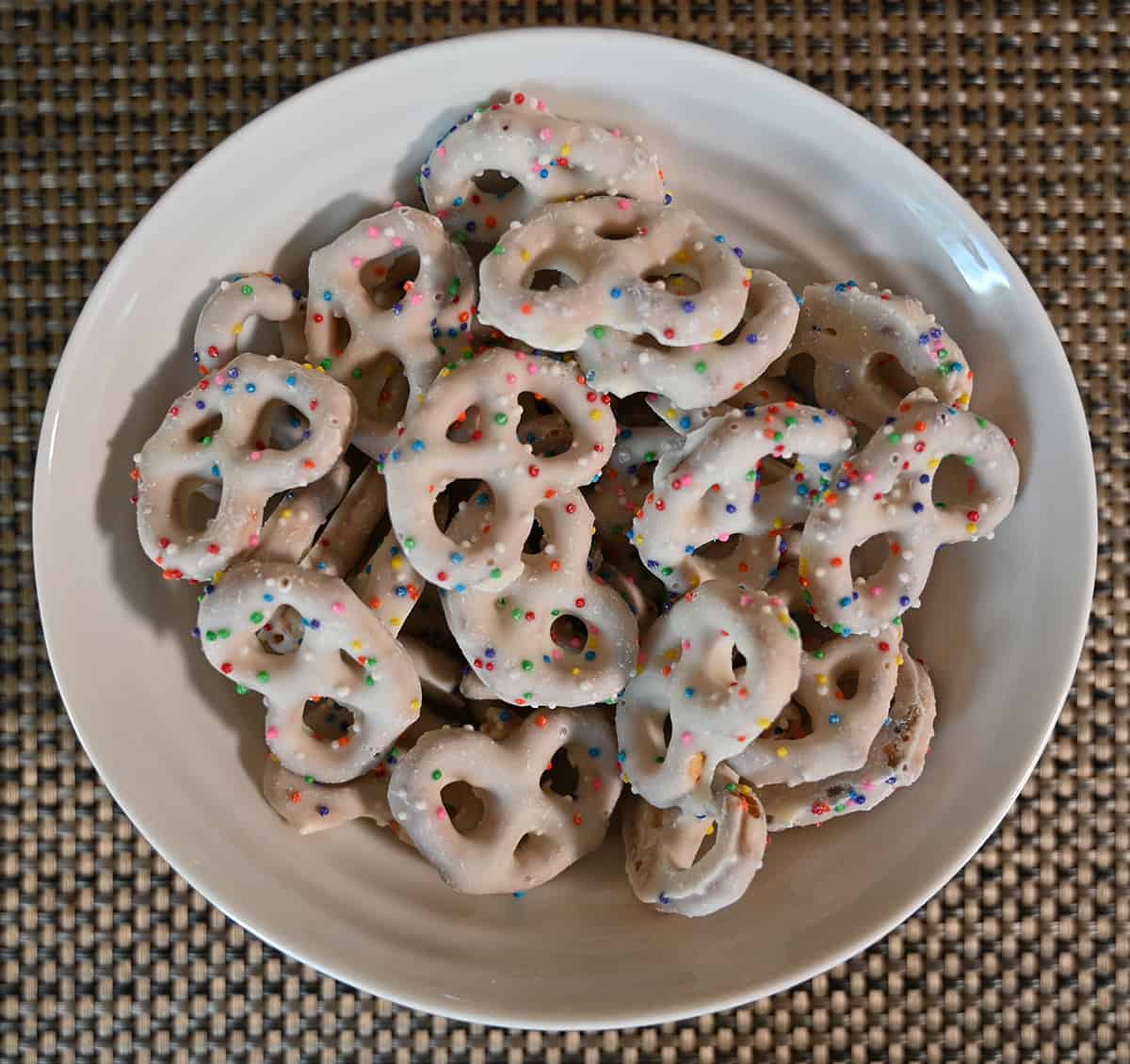 Closeup top down image of a bowl of birthday cake yogurt pretzels.