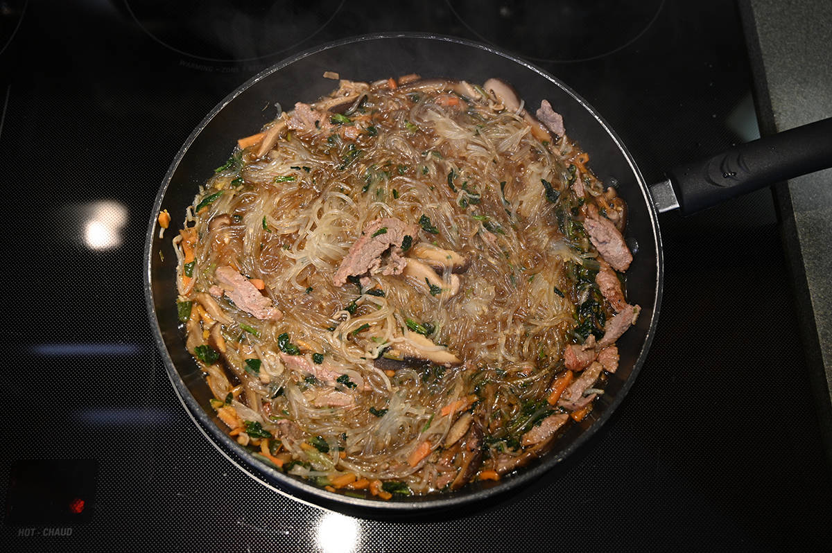 Top down image of the prepared japchae in a pan on the stove.