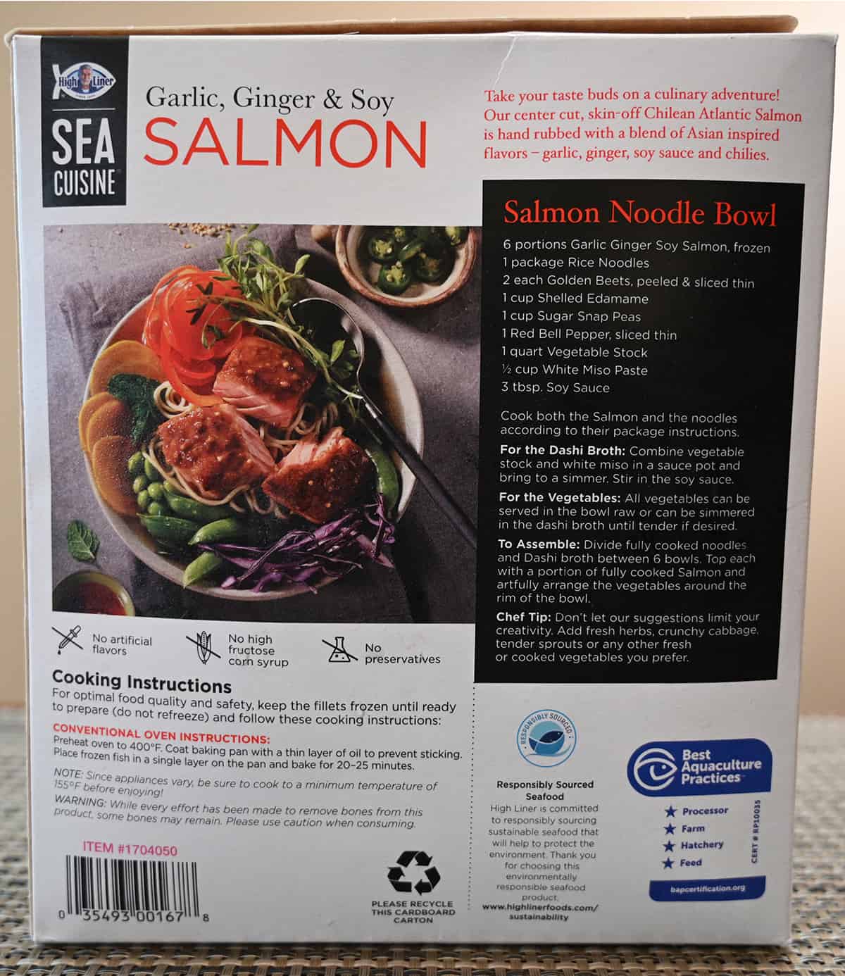 Closeup image of the back of the box of salmon showing the product description, cooking instructions and a recipe for a salmon noodle bowl.