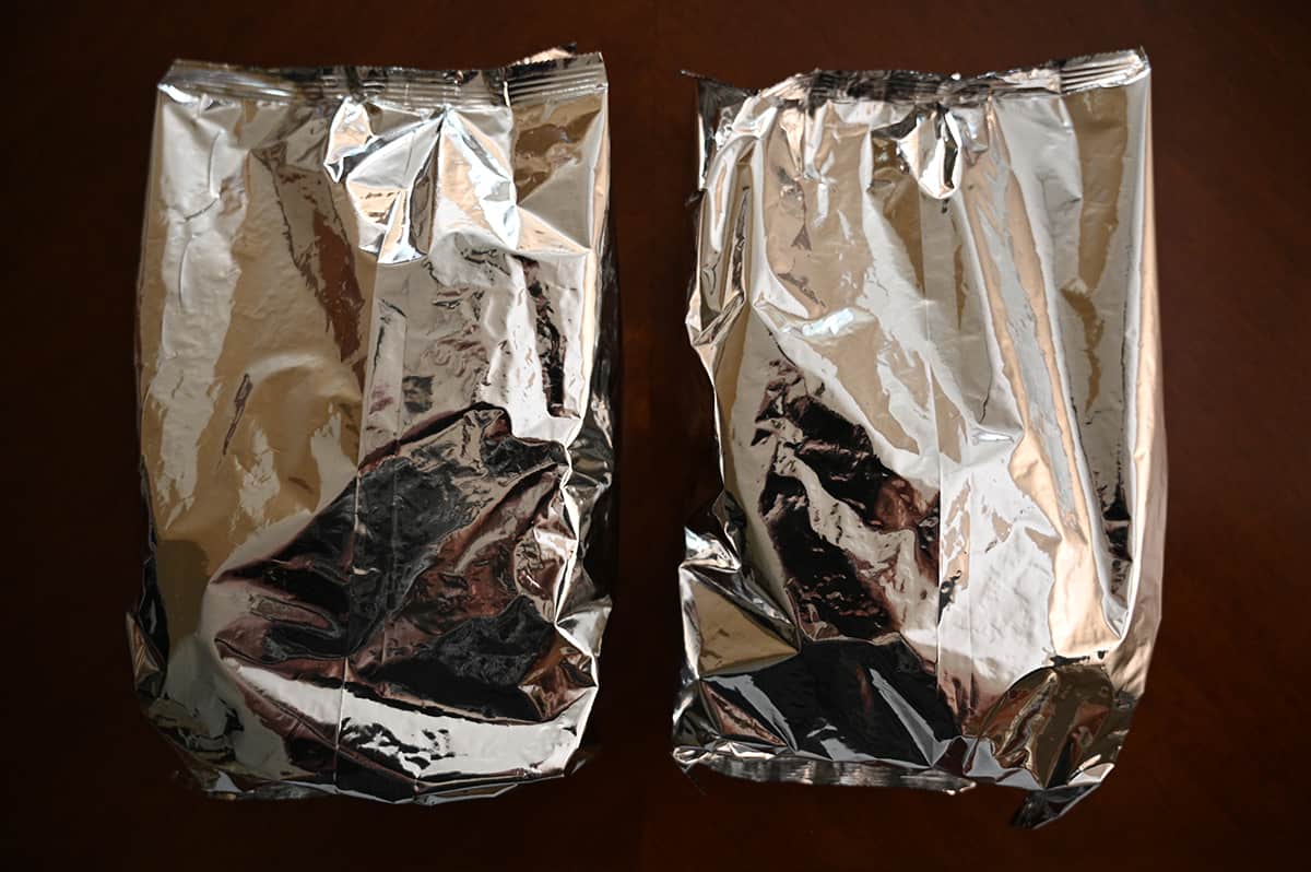 Top down image of two unopened bag of crackers sitting on a table.