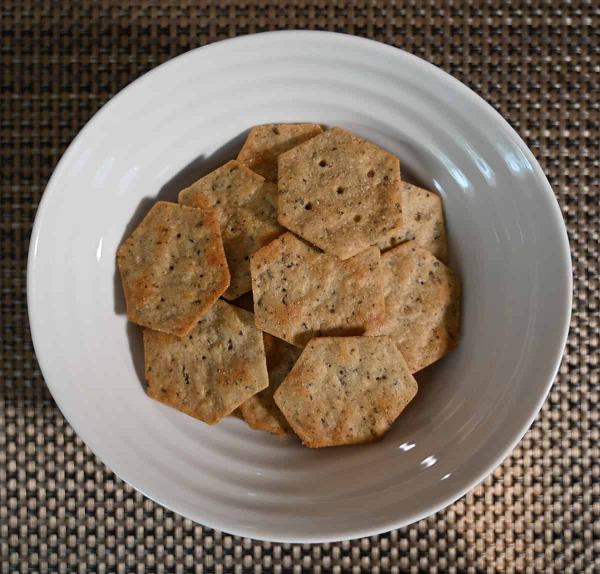 Top down image of a white bowl filled with crackers.