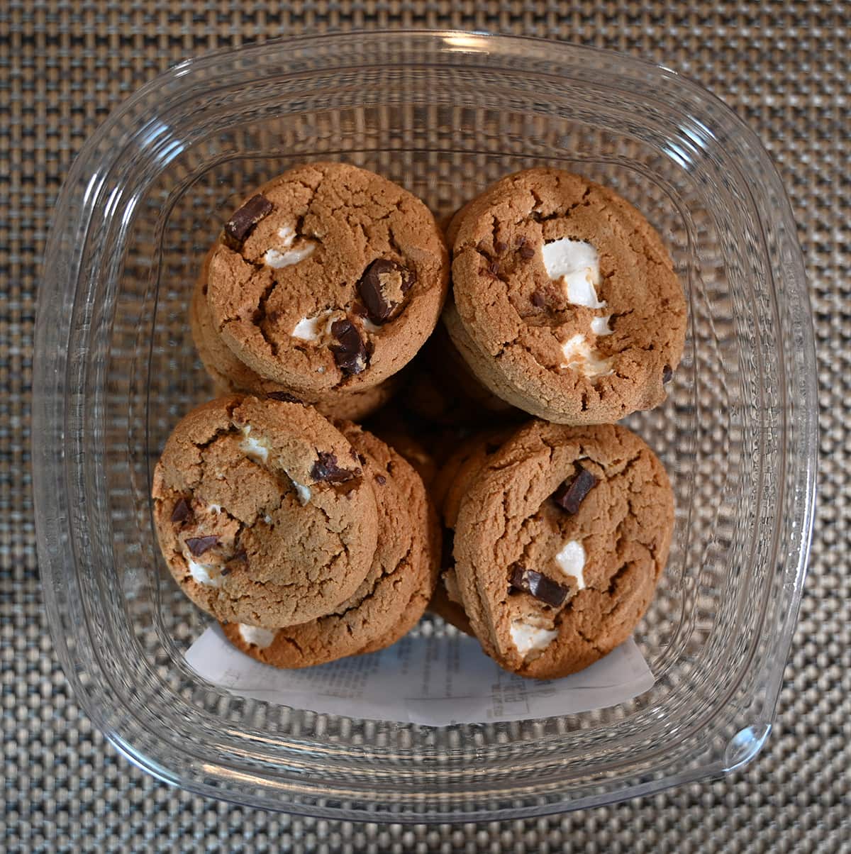 Top down image of the cookie container open and sitting on a table, you can see what the cookies look like.