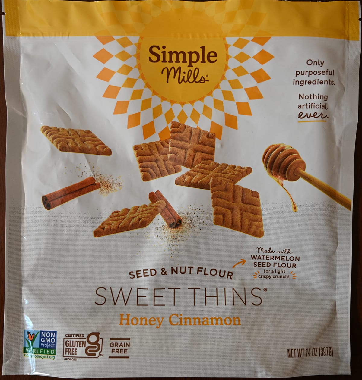 Closeup image of the front of the honey cinnamon Sweet Thins bag showing the weight and that they're Non-GMO