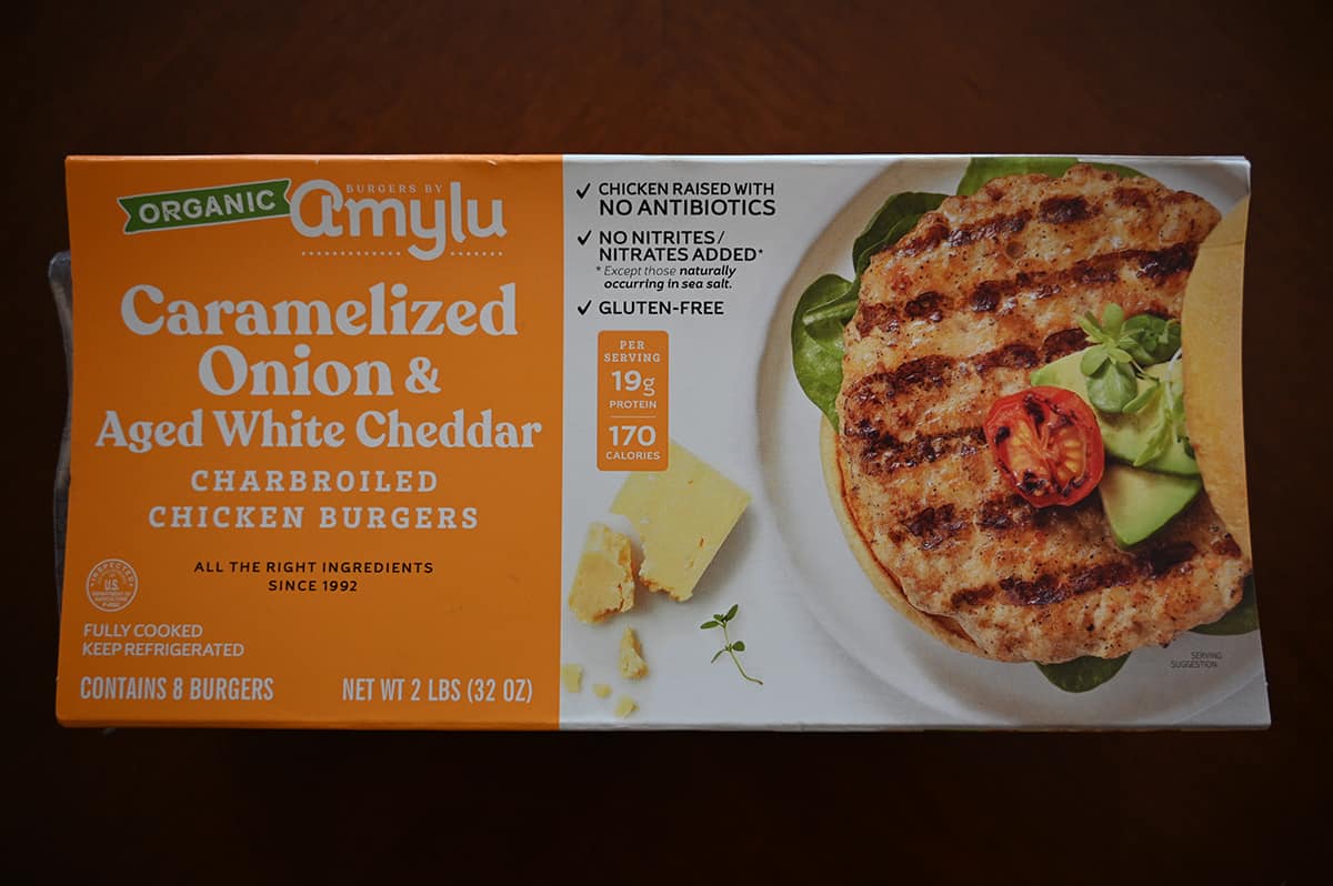 Image of the Costco Amylu Caramelized Onion & Aged White Cheddar Chicken Burgers box sitting on a table unopened.