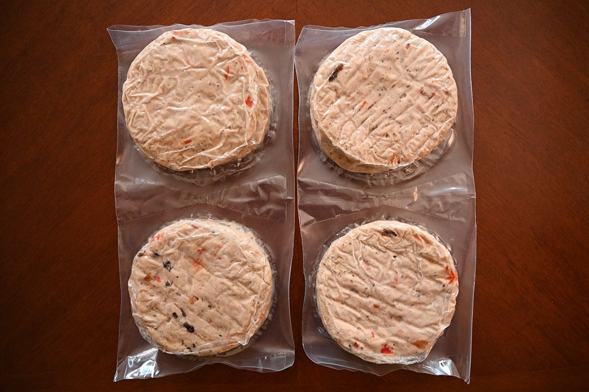 Top down image showing the chicken burgers packaged in plastic vacuum packs. Two burgers per pack.