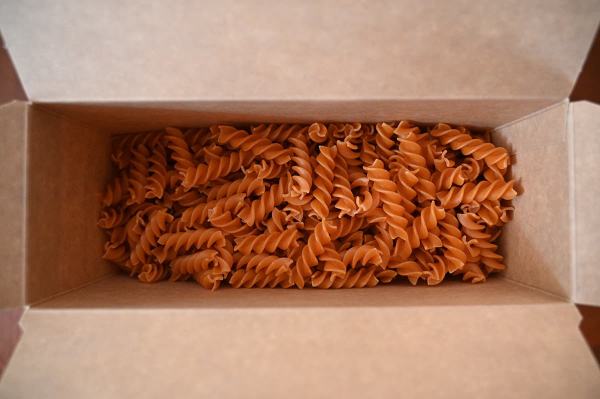 Top down image of a box of Chickapea pasta open so you can see the pasta, dry, in the box.